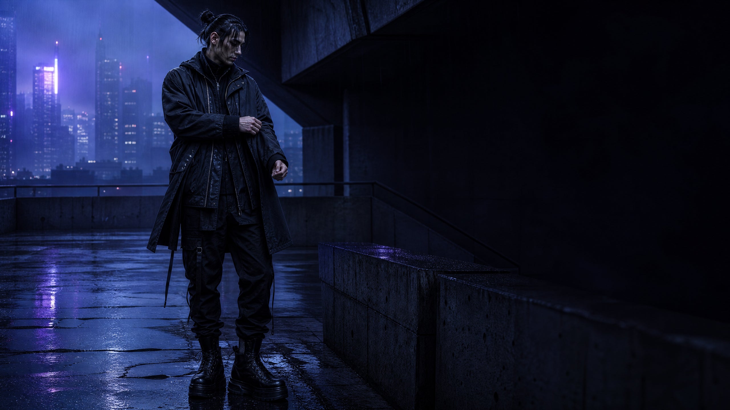 Black layered techwear outfit on a brutalist rain-slick city walkway at night