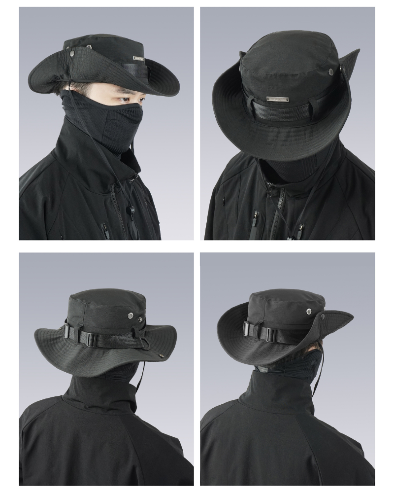 Black hat with face covering worn by a person on a gray background
