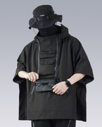 Person wearing a black tactical poncho with a face mask on a gray background