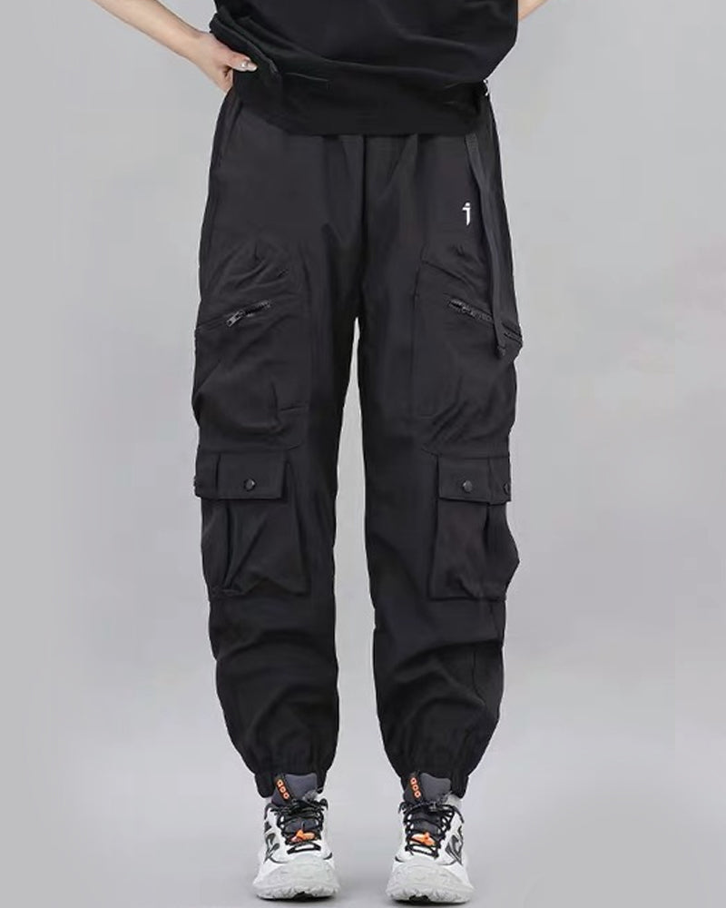 Black cargo pants worn by a person on a gray background