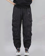 Black cargo pants worn by a person on a gray background
