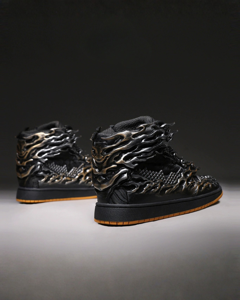Black high-top sneakers with metallic flame design on a dark background
