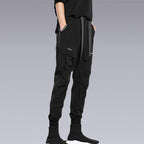A man wearing the black Tech wear pants and putting his hand inside the pocket