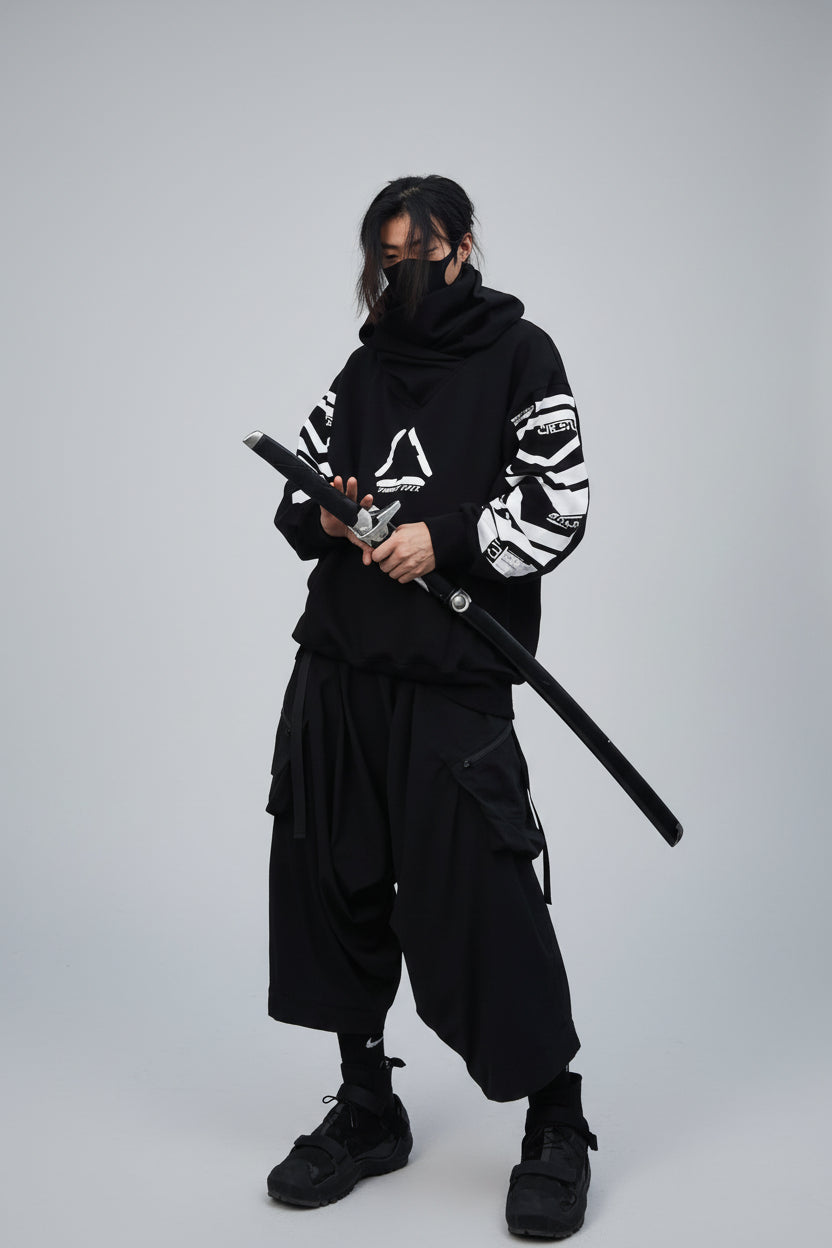 Person in dark outfit holding a sword against a textured wall.