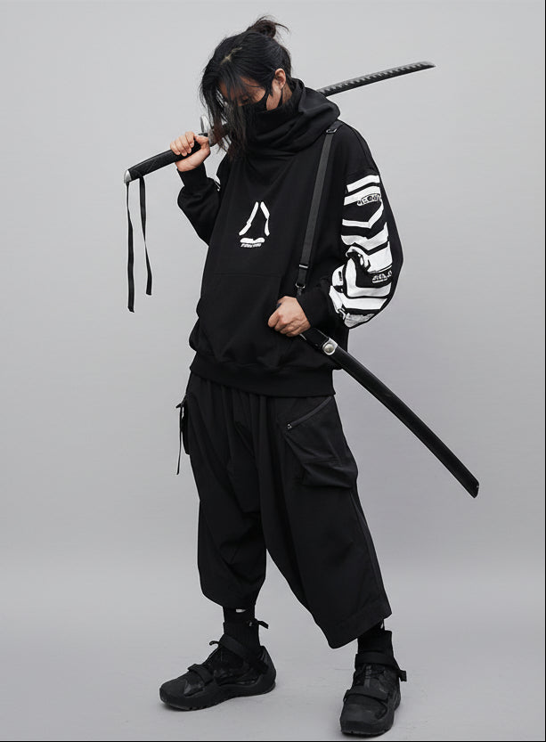 Person in black outfit holding a sword against a textured wall.