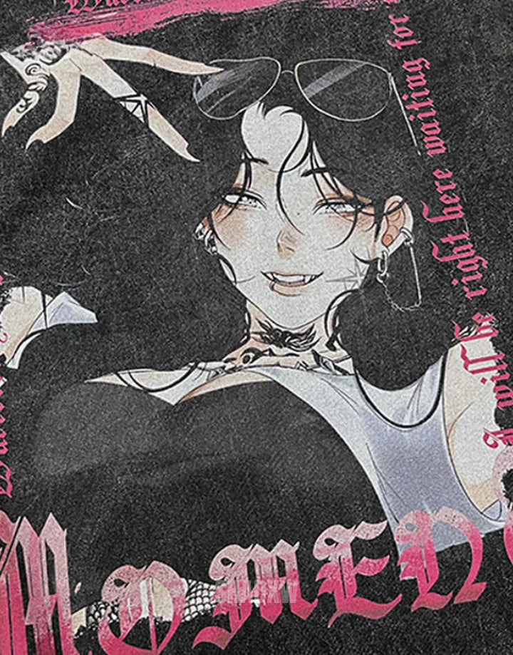 Close-up of a black graphic T-shirt featuring an illustrated anime-style woman with dark hair, sunglasses, and gothic-style pink text and lettering.