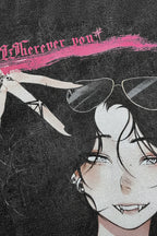 Close-up of a graphic print featuring an illustrated anime-style face with dark hair, sunglasses, and a pink brushstroke accent with gothic text at the top.