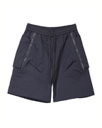Black techwear shorts with zippers on a white background