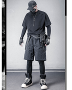 Person wearing a black outfit with tactical gear in an urban setting