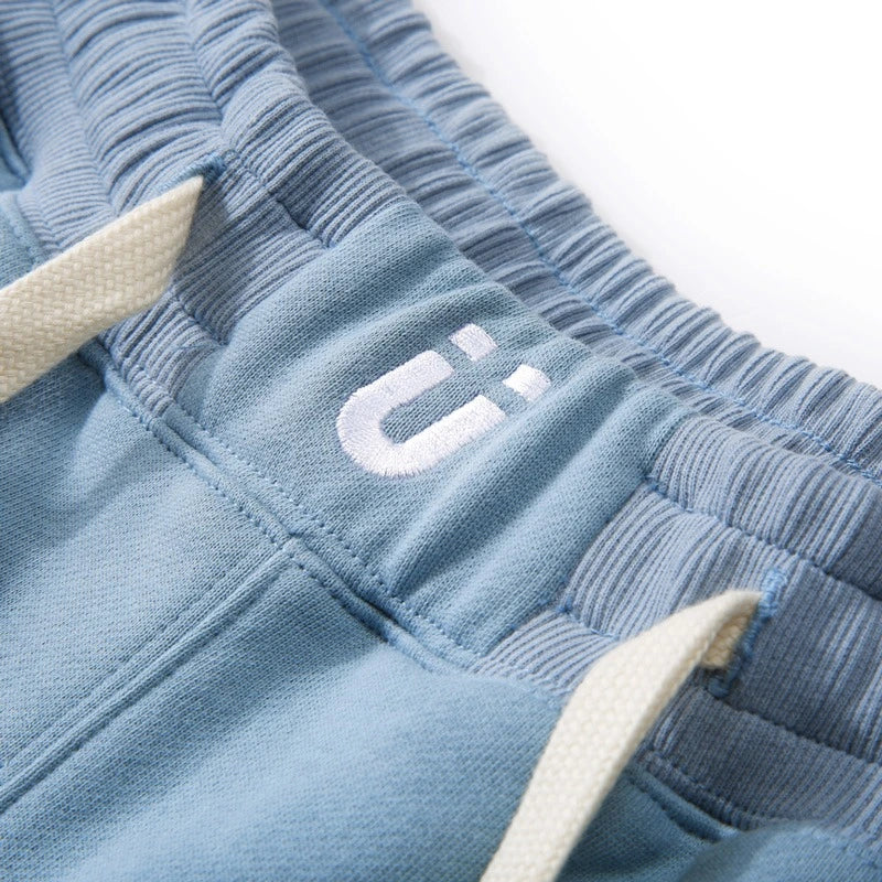 Teenager wearing light blue fake two-piece shorts with athletic shoes.