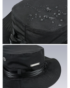 Black rain  tactical hat with water droplets on top and a brand label on a gray background.