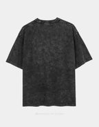 A dark gray acid-wash short-sleeve t-shirt shown from the back, featuring a faded mineral-wash finish and raw hem, displayed on a light gray background.