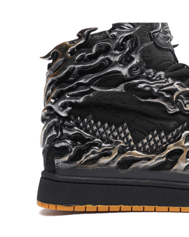 Close-up of a black and silver sneaker with detailed design on a white background