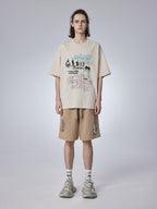 Teenager wearing trendy khaki shorts with a playful cat print. Cropped length and mid-rise waist for summer comfort.