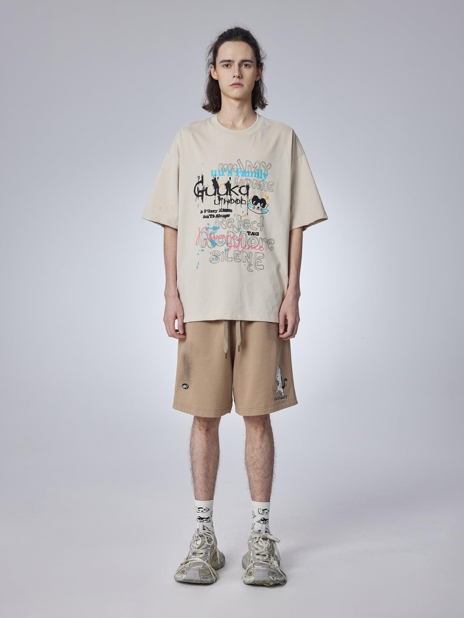 Teenager wearing trendy khaki shorts with a playful cat print. Cropped length and mid-rise waist for summer comfort.