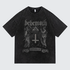 A washed black short-sleeve t-shirt featuring a dark gray gothic graphic print of the band Behemoth with their 'Shavhsis' album artwork on the front, displayed against a light gray background.