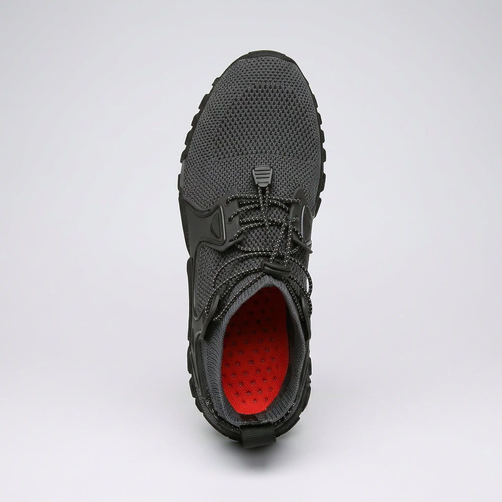 A single dark gray knit athletic shoe shown from a top-down view, featuring a bright red interior lining.