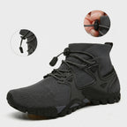 A dark gray and black high-top athletic shoe with a breathable mesh upper, black laces, and a rugged sole. Two circular inset images at the top show close-up details of the lace closure and heel adjustment. Techwear Shoes Airflow Sneakers – Techwear Gray / Black shoes