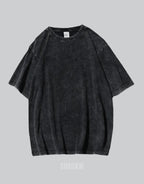 Oversized washed black techwear t-shirt with a long hem, muted charcoal finish, and minimalist urban streetwear styling — view 2