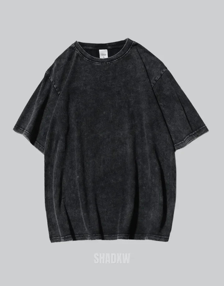 Oversized washed black techwear t-shirt with a long hem, muted charcoal finish, and minimalist urban streetwear styling — view 2