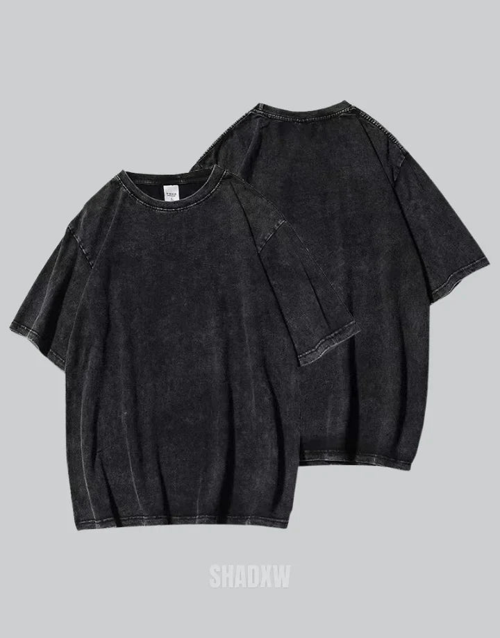 Oversized washed black techwear t-shirt with a long hem, muted charcoal finish, and minimalist urban streetwear styling — view 3