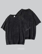 Oversized washed black techwear t-shirt with a long hem, muted charcoal finish, and minimalist urban streetwear styling — view 3