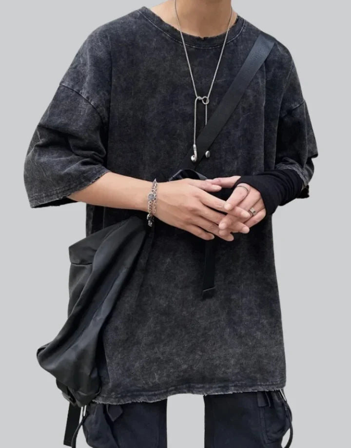 Oversized washed black techwear t-shirt with a long hem, muted charcoal finish, and minimalist urban streetwear styling — view 1