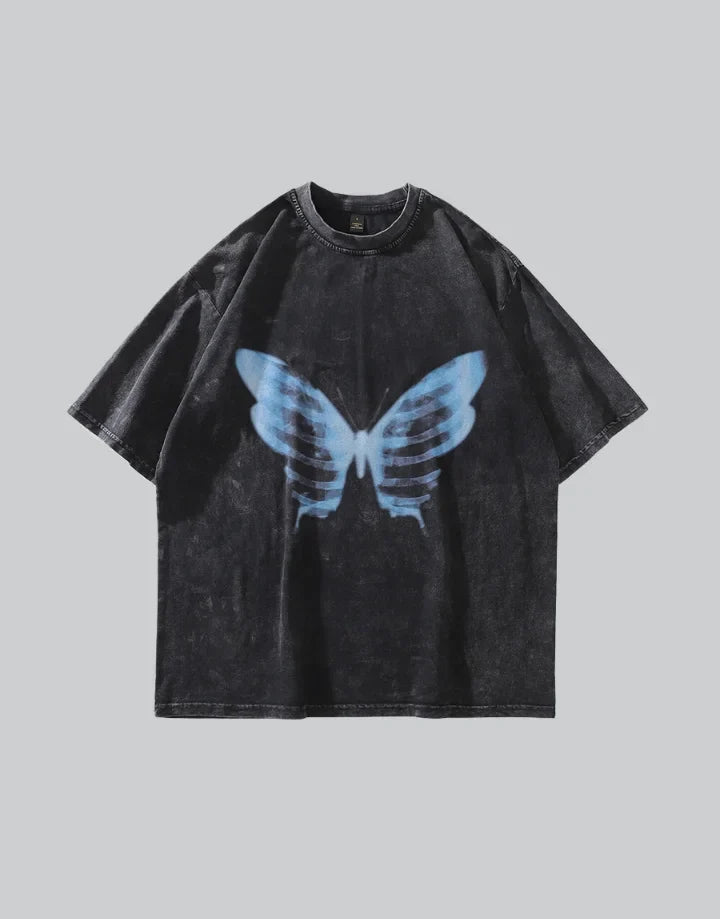 Dark oversized graphic tee with butterfly and skull motif, combining floral and skeletal elements on a longline techwear silhouette — view 1