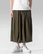 Clotechnow calf-length army green hakama pants with a wide-leg draped silhouette worn with white sneakers