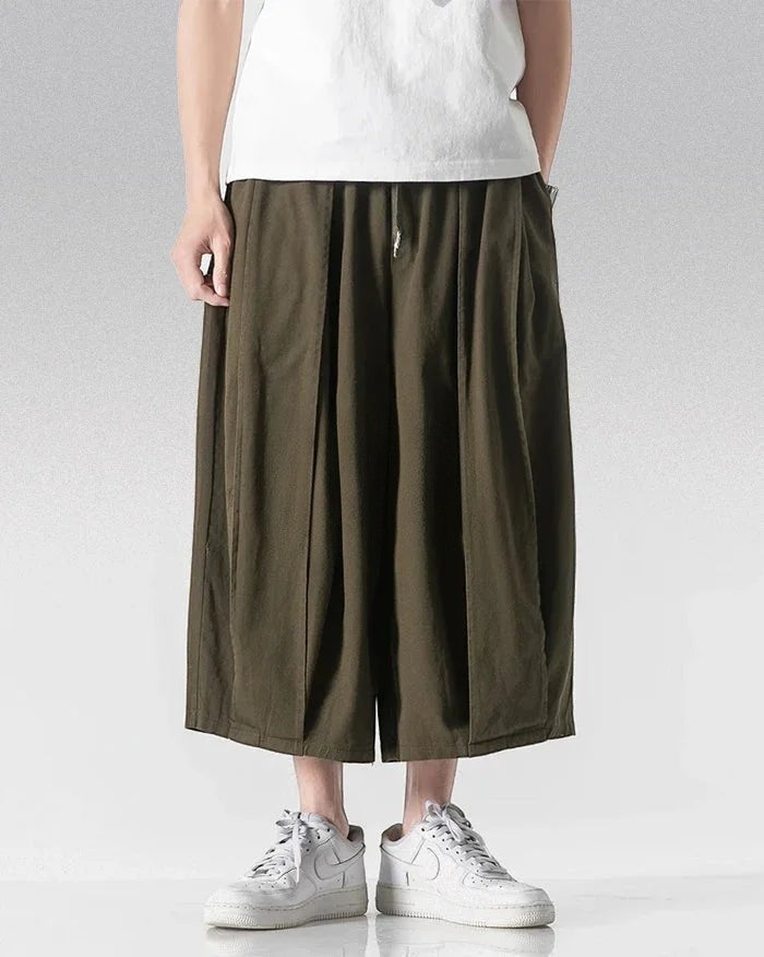 Clotechnow calf-length army green hakama pants with a wide-leg draped silhouette worn with white sneakers