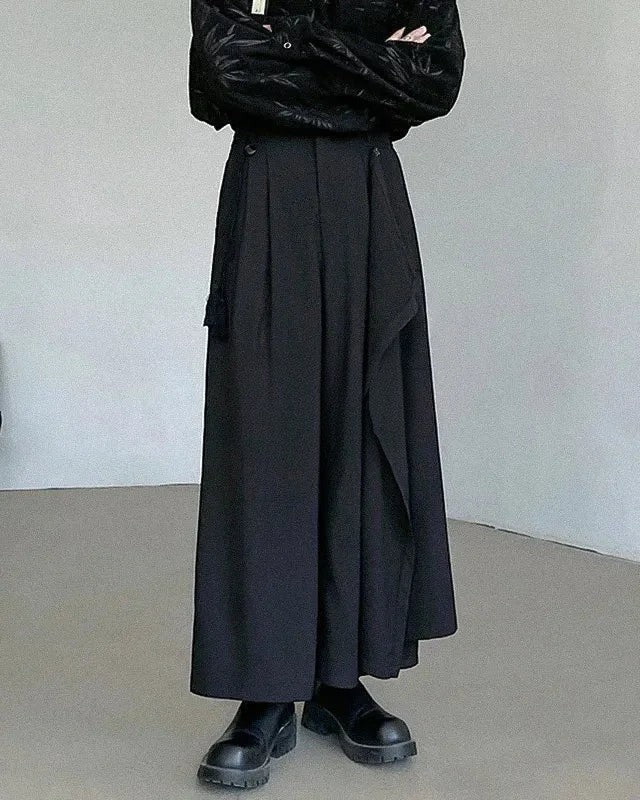 Clotechnow black asymmetric layer hakama pants with a wide-leg draped silhouette worn with black boots