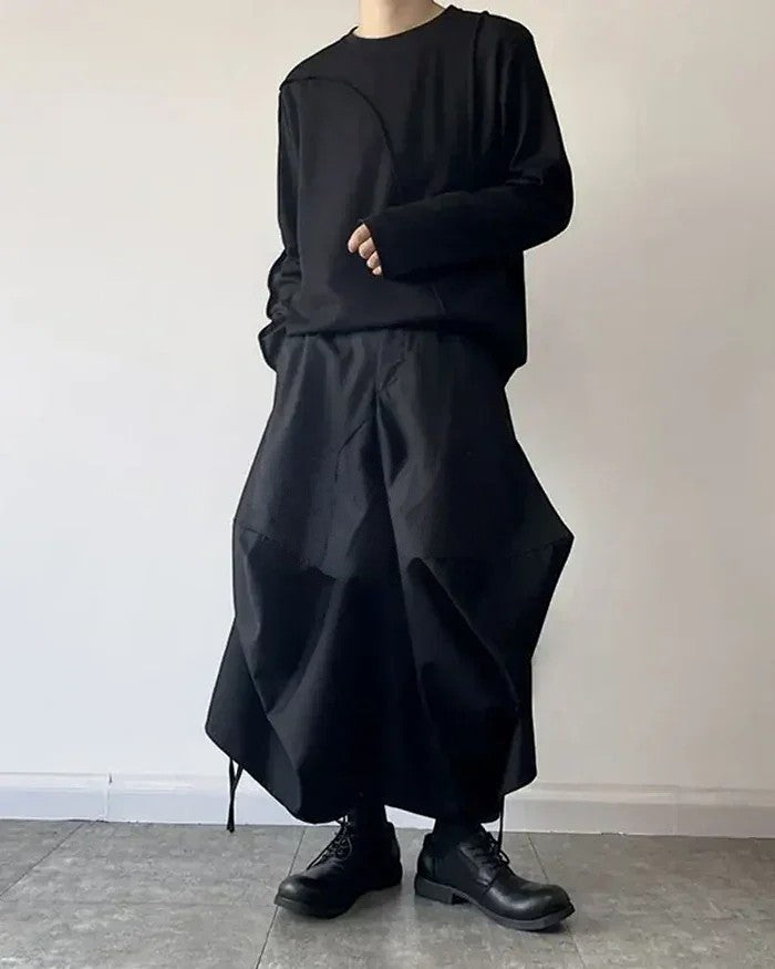 Clotechnow black baggy hakama pants with a wide-leg draped silhouette worn with a matching long-sleeve top