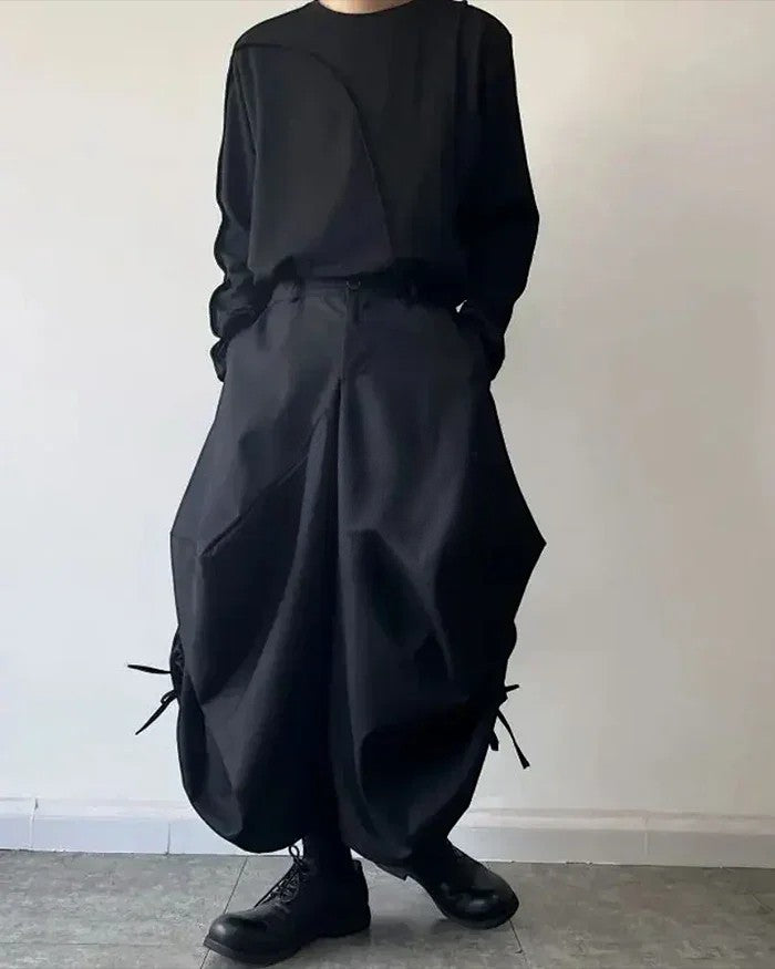 Clotechnow black baggy hakama pants with a wide-leg draped silhouette and side tie details worn with a black top