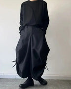 Clotechnow black baggy hakama pants with a wide-leg draped silhouette and side tie details worn with a black top