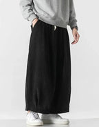 Clotechnow black cord texture hakama pants with a wide-leg draped silhouette worn with a grey sweatshirt and sneakers