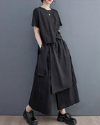 Model wearing Clotechnow black double-layer wide-leg hakama pants with a matching short-sleeve top and black shoes.