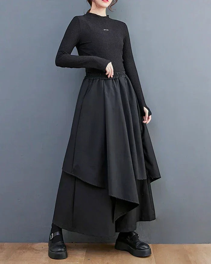 Clotechnow black formal drape hakama pants with a wide-leg layered silhouette worn with a matching long-sleeve top.