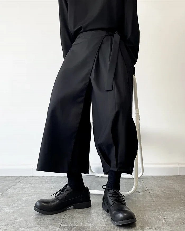 Clotechnow black kimono cut hakama pants with a wide-leg draped silhouette and tie-waist detail on a model.