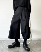 Clotechnow black kimono cut hakama pants with a wide-leg draped silhouette and tie-waist detail on a model.