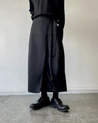 Clotechnow black kimono cut hakama pants with a wide-leg draped silhouette and wrap-style front detail.