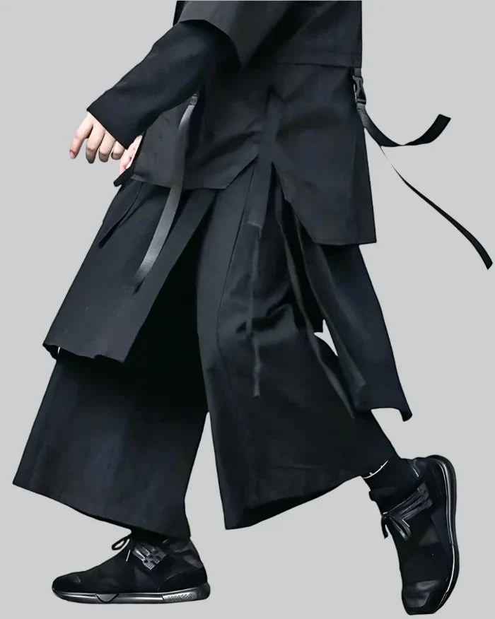 Clotechnow black pleated hakama pants featuring a wide-leg silhouette and layered design worn with matching top