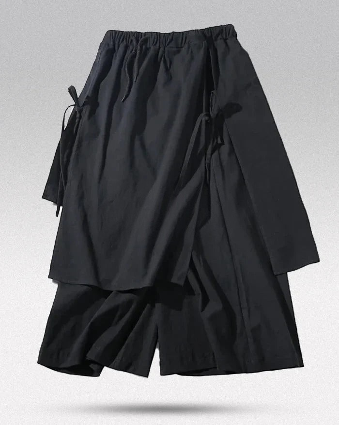 Clotechnow black wide-leg hakama pants with traditional pleats and side tie closures for a modern silhouette.