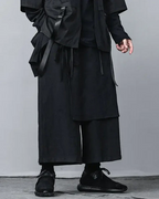 Clotechnow black pleated hakama pants with a wide-leg silhouette worn with a matching jacket and black sneakers
