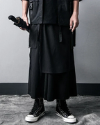Clotechnow black pleated hakama pants with wide-leg silhouette styled with a techwear vest and high-top sneakers