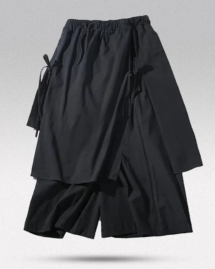 Clotechnow black wide-leg hakama pants featuring a layered pleated design and side tie closures.
