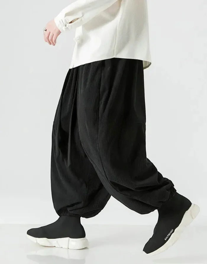 Clotechnow black wide-leg hakama pants with ribbon tie detail, styled with a white top and black sneakers