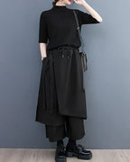 Clotechnow black sculpted hakama pants with a wide-leg draped silhouette, drawstring waist, and layered fabric panels.