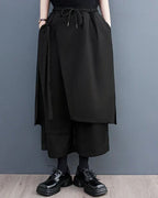 Clotechnow black sculpted hakama pants with a wide-leg draped silhouette, elastic waist, and layered front panel