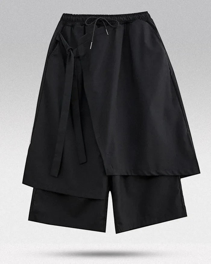 Clotechnow black sculpted hakama pants with a wide-leg draped silhouette and an adjustable drawstring waist.