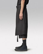 Clotechnow black short-length hakama pants with a wide-leg draped silhouette, side view on a model.